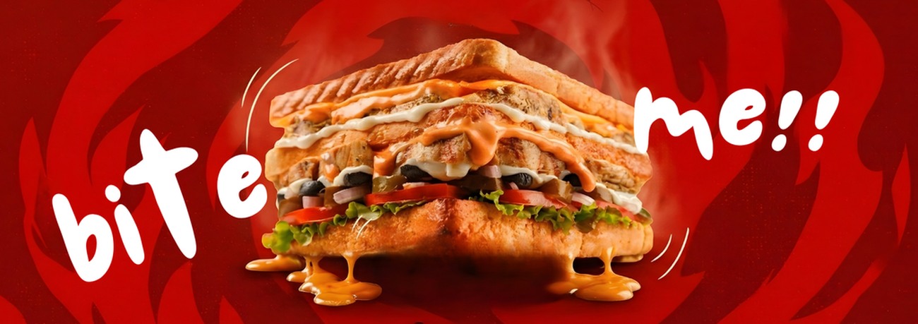 Dagwood brand photography: a stacked chicken sandwich shot close and warm against the brand red